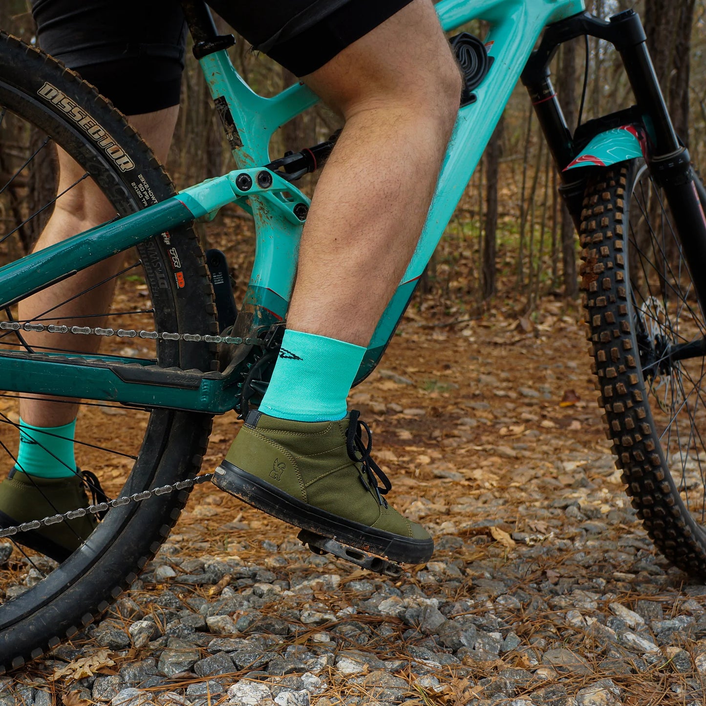 cyclist wearing DeFeet Aireator 3" cycling socks in light teal